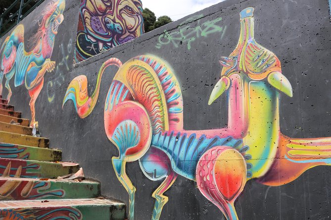 Graffiti Tour in La Candelaria Bogotá with Transportation - A narrow street filled with Indigenous themes