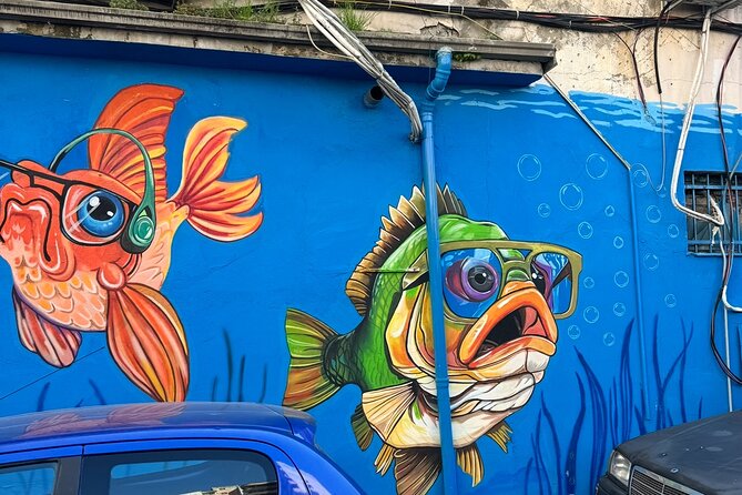 Tirana Mural Bike Tour: Street Art, Culture & Photography Stops - Lokomotiva, a former railway site with a painted tank