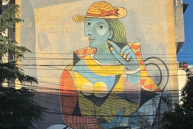Tirana Mural Bike Tour: Street Art, Culture & Photography Stops - Small-scale surprises at the DOG and Mots mural